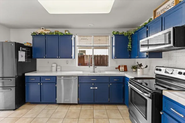a kitchen with stainless steel appliances granite countertop a stove a sink dishwasher and a refrigerator