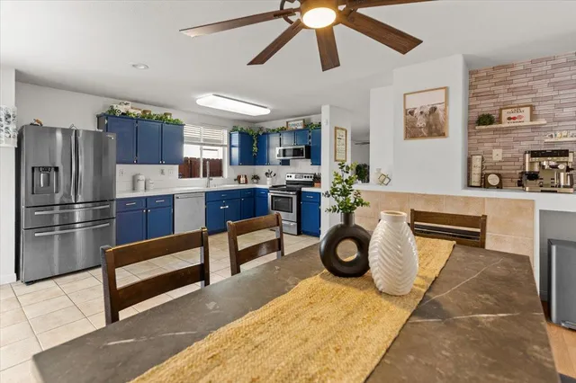 a kitchen with stainless steel appliances granite countertop a stove refrigerator and cabinets