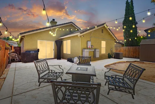 a view of a patio with couches chairs and wooden floor