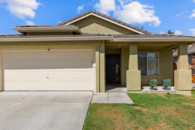 a view of a house with a large window and yard