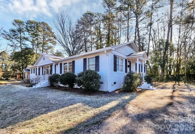 a front view of a house with a yard covered outdoor seating