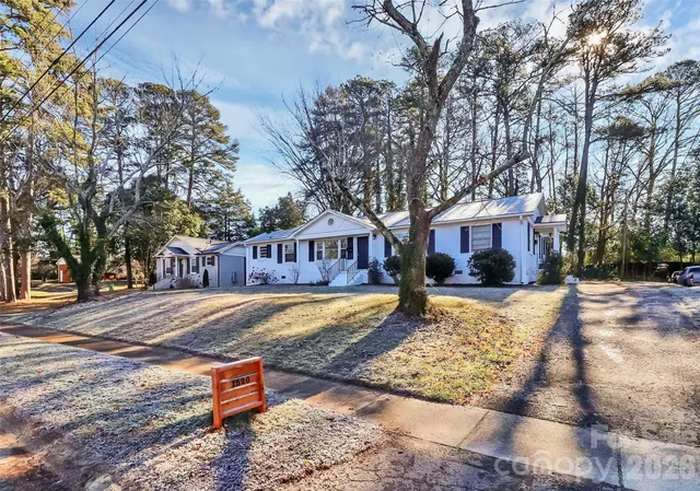 a front view of a house with a yard covered with snow