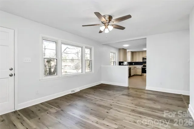 a view of a kitchen with a dishwasher cabinets and wooden floor