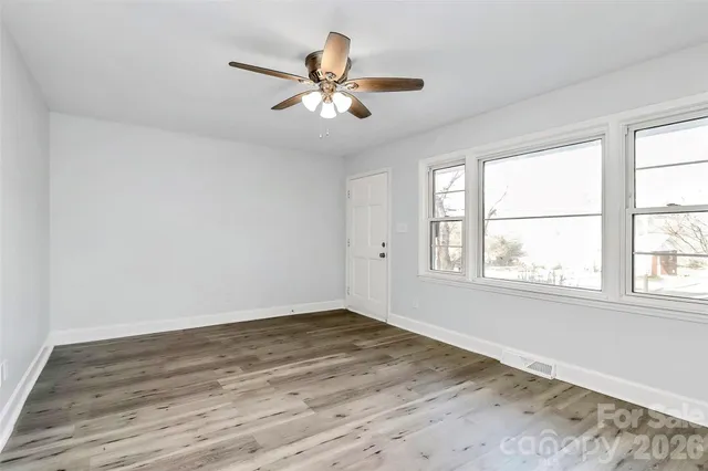 wooden floor in an empty room with a window