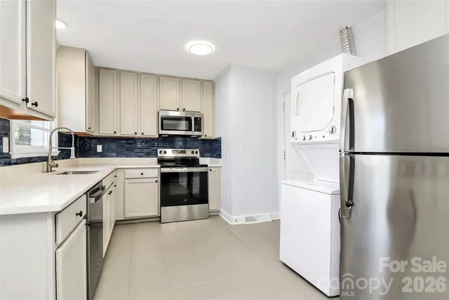 a kitchen with a refrigerator sink and stove