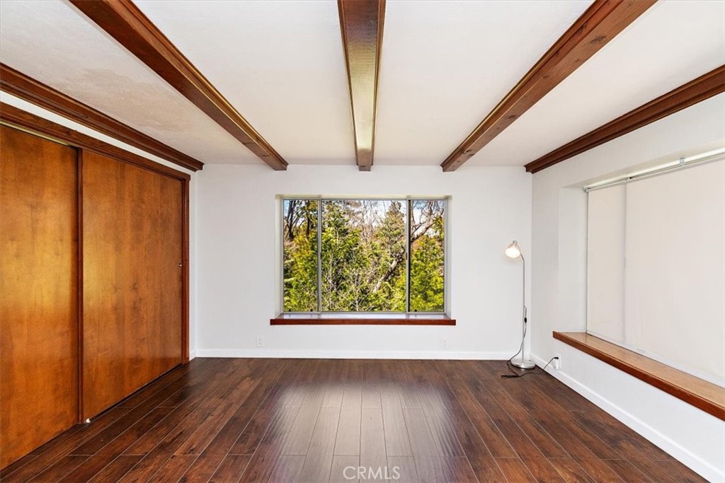26432 Lake Forest Drive Twin Peaks, CA 92391 - Photo 16 of 27 a view of an empty room with wooden floor and a window