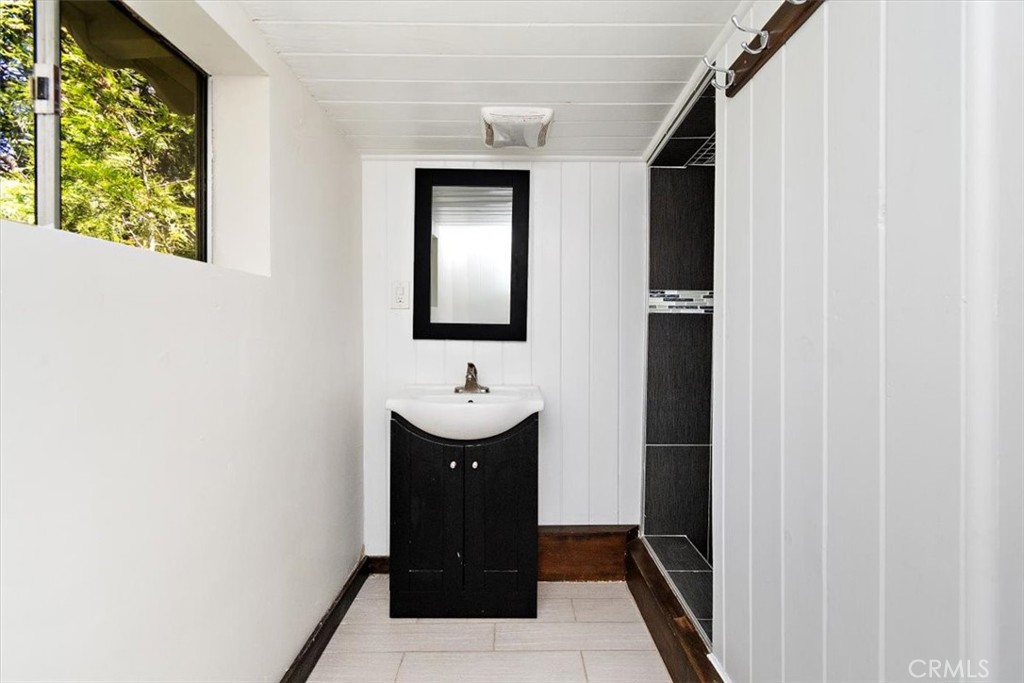 26432 Lake Forest Drive Twin Peaks, CA 92391 - Photo 19 of 27 a bathroom with a sink and a mirror