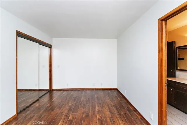 an empty room with wooden floor and a window