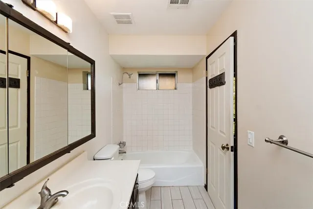 a bathroom with a tub and shower