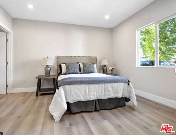 a bed sitting in a bedroom next to a window