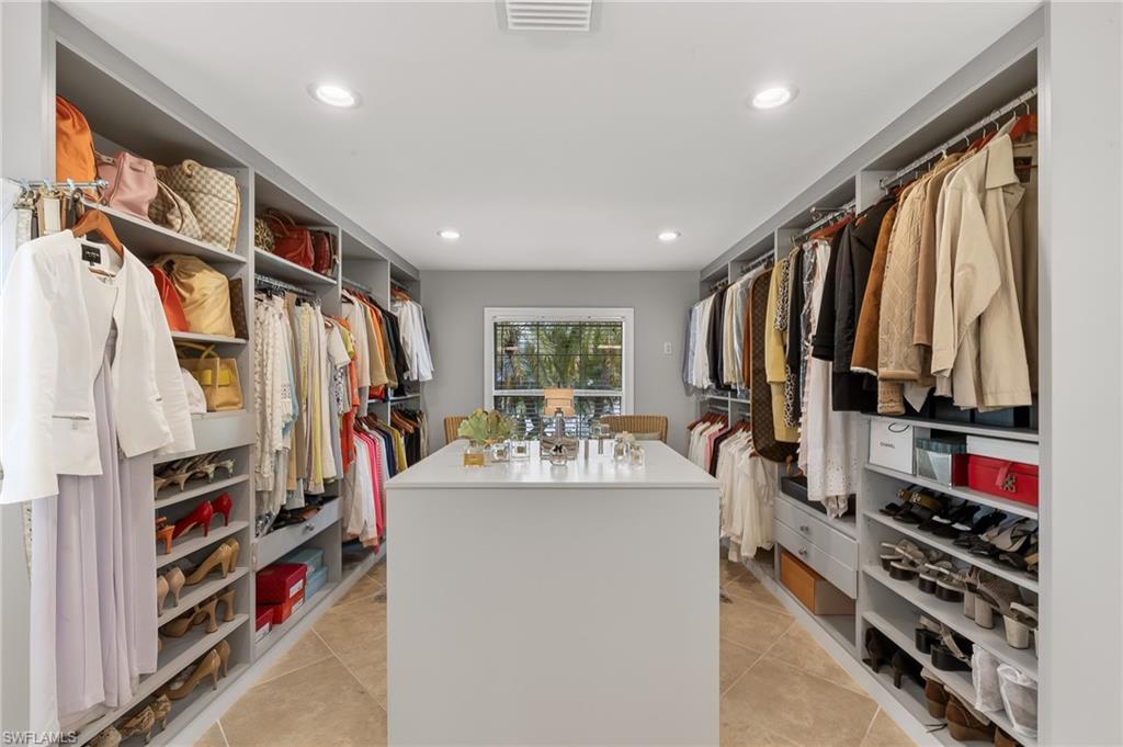 1904 Countess Court Naples, FL 34110 - Photo 16 of 33 a view of walk in closet with clothes and shoes