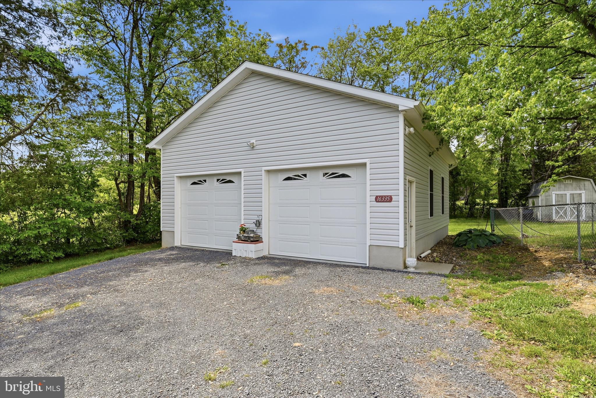 16335 Back Road Strasburg, VA 22657 - Photo 43 of 56 a view of a house with a yard and garage