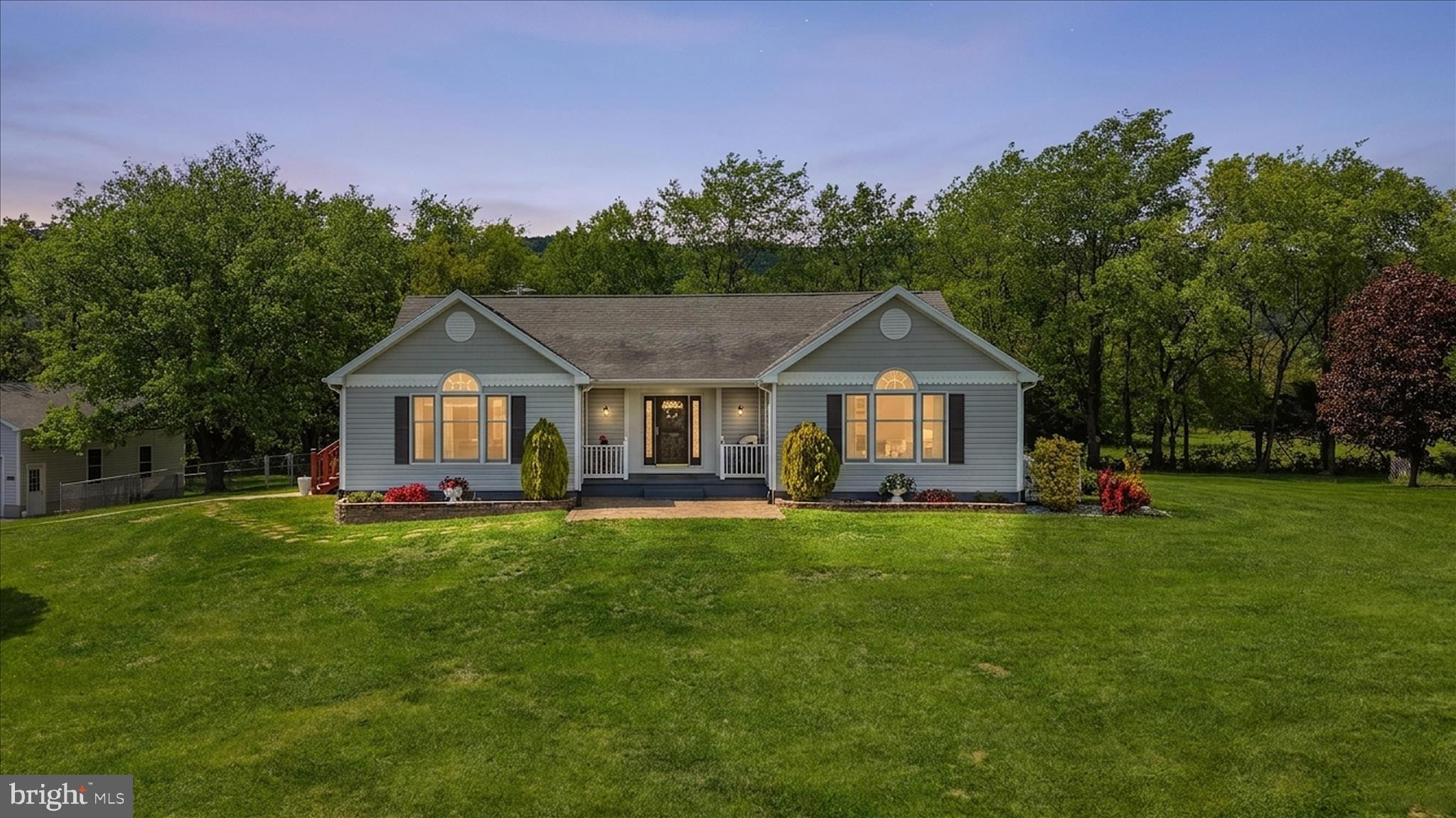 16335 Back Road Strasburg, VA 22657 - Photo 55 of 56 a front view of a house with a garden and trees