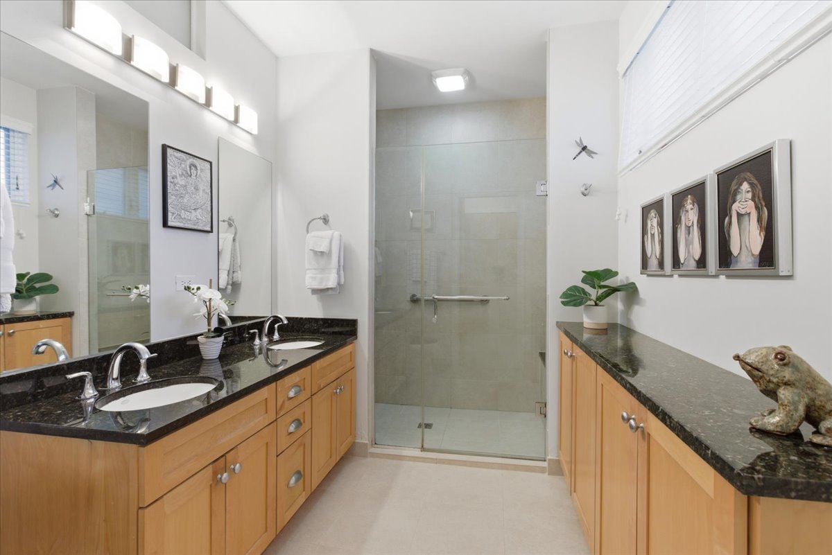 2515 Prairie Avenue, Unit 1E Evanston, IL 60201 - Photo 11 of 17 a bathroom with a granite countertop sink a mirror and a shower