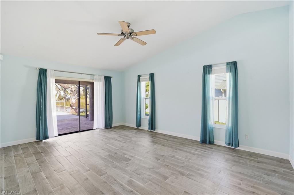 6735 Plantation Manor Loop Fort Myers, FL 33966 - Photo 15 of 46 a view of a big room with wooden floor and windows