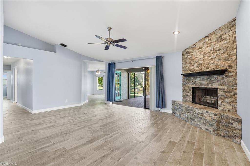 6735 Plantation Manor Loop Fort Myers, FL 33966 - Photo 22 of 46 a view of an empty room with a fireplace and a window