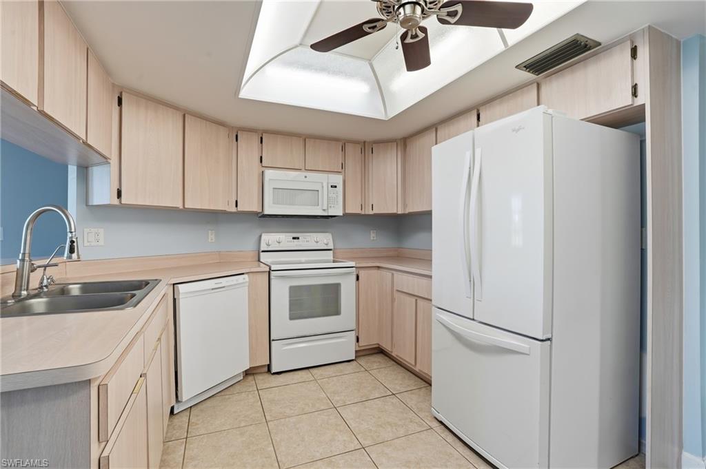 6735 Plantation Manor Loop Fort Myers, FL 33966 - Photo 24 of 46 a kitchen with white cabinets and white appliances