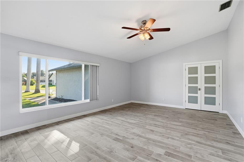 6735 Plantation Manor Loop Fort Myers, FL 33966 - Photo 27 of 46 a view of an empty room with window and wooden floor