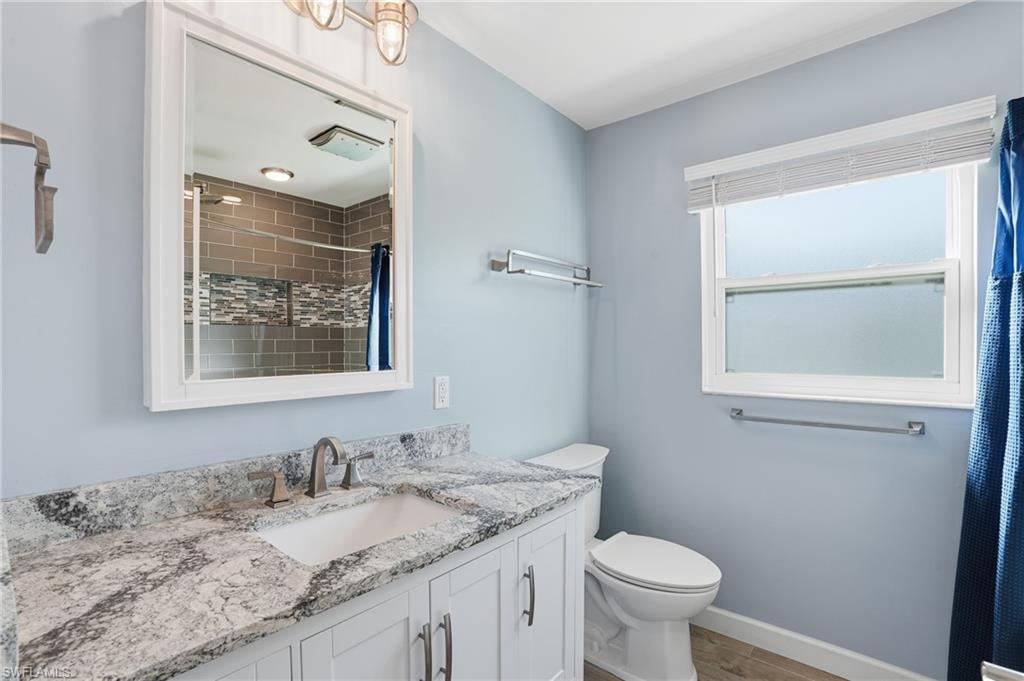 6735 Plantation Manor Loop Fort Myers, FL 33966 - Photo 32 of 46 a bathroom with a granite countertop toilet sink and mirror