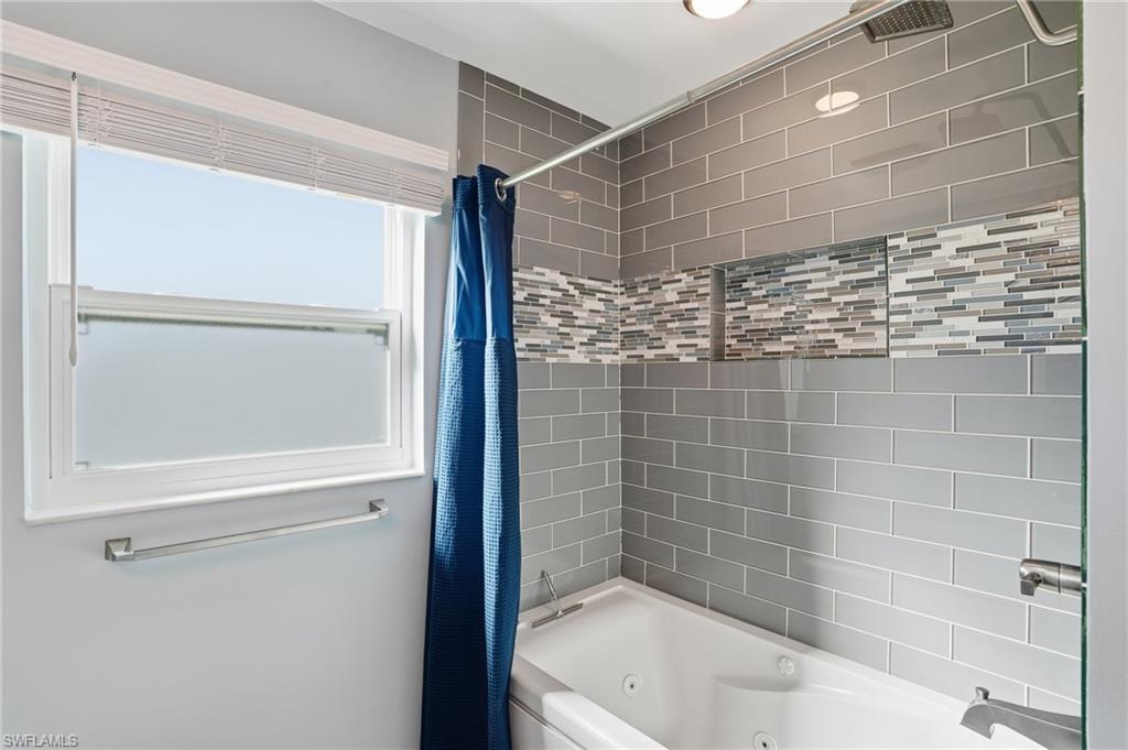 6735 Plantation Manor Loop Fort Myers, FL 33966 - Photo 33 of 46 a bathroom with a bathtub and a shower