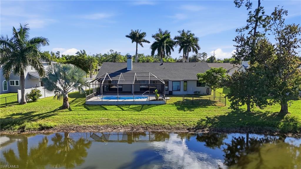 6735 Plantation Manor Loop Fort Myers, FL 33966 - Photo 4 of 46 a swimming pool with trees in the background