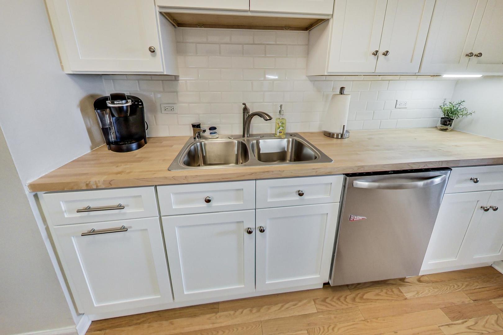 1350 North Astor Street, Unit 8B Chicago, IL 60610 - Photo 14 of 27 a kitchen with white cabinets and sink