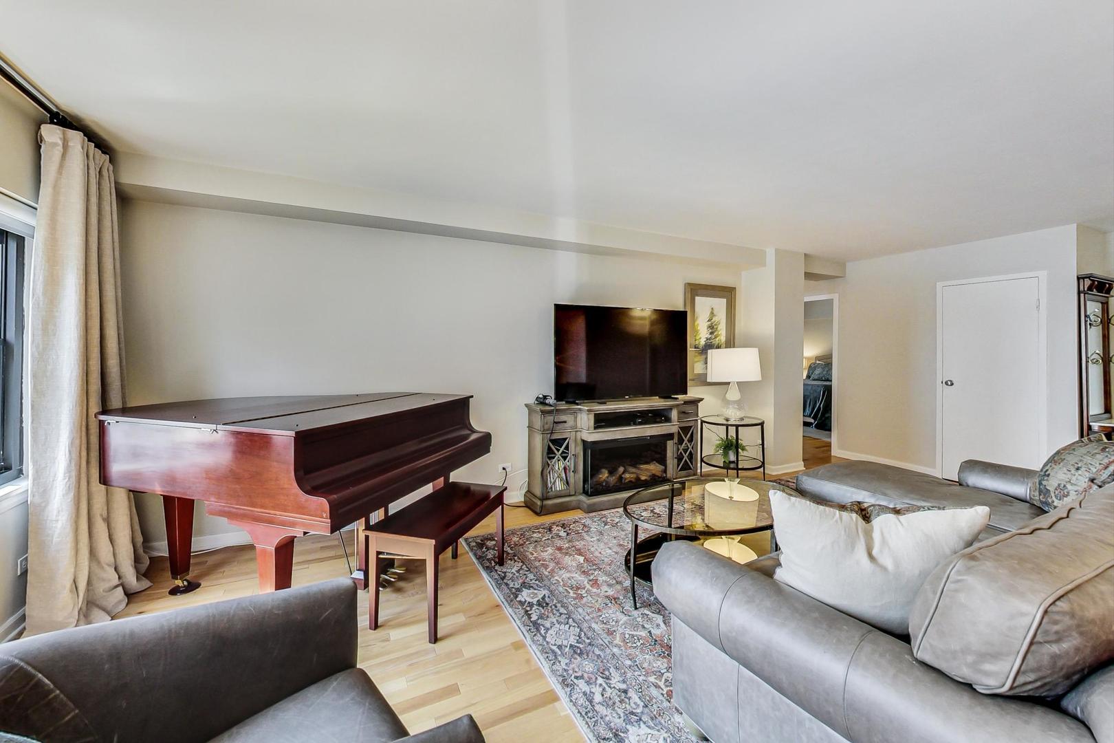 1350 North Astor Street, Unit 8B Chicago, IL 60610 - Photo 6 of 27 a living room with furniture and a flat screen tv