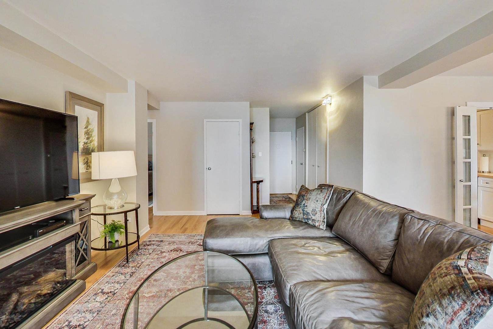 1350 North Astor Street, Unit 8B Chicago, IL 60610 - Photo 7 of 27 a living room with furniture and a flat screen tv