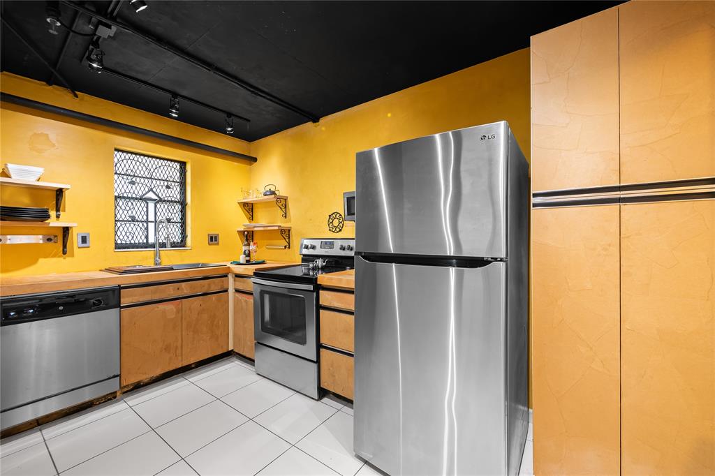 3300 West Rolling Hills Circle, Unit 610 Davie, FL 33328 - Photo 13 of 22 a kitchen with stainless steel appliances granite countertop a refrigerator a sink and a stove