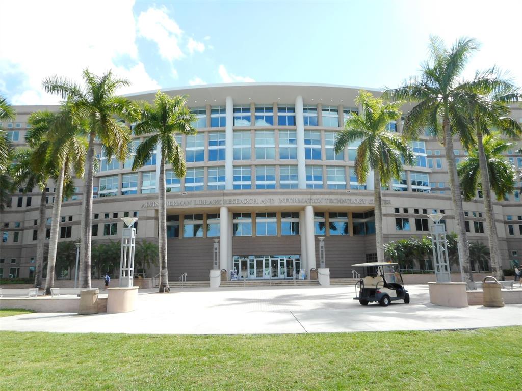 3300 West Rolling Hills Circle, Unit 610 Davie, FL 33328 - Photo 21 of 22 a view of a building with a patio and a yard
