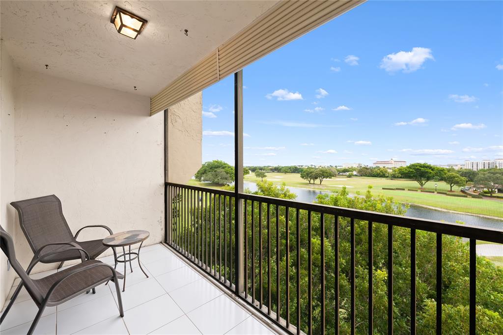 3300 West Rolling Hills Circle, Unit 610 Davie, FL 33328 - Photo 5 of 22 a view of a balcony with chair and floor to ceiling window