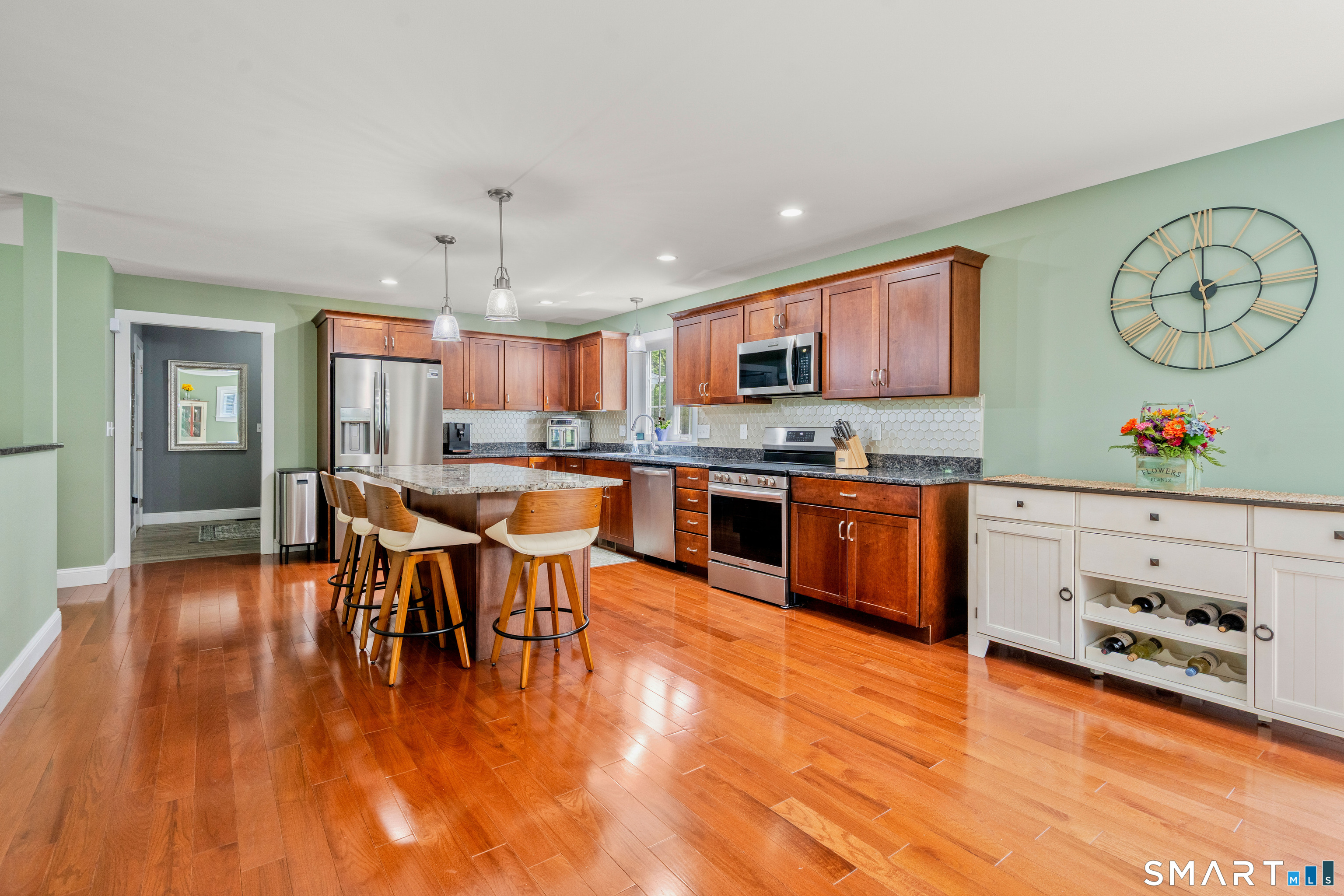 5 Limric Lane Suffield, CT 06078 - Photo 7 of 36 a kitchen with stainless steel appliances granite countertop a stove top oven a sink dishwasher and white cabinets with wooden floor