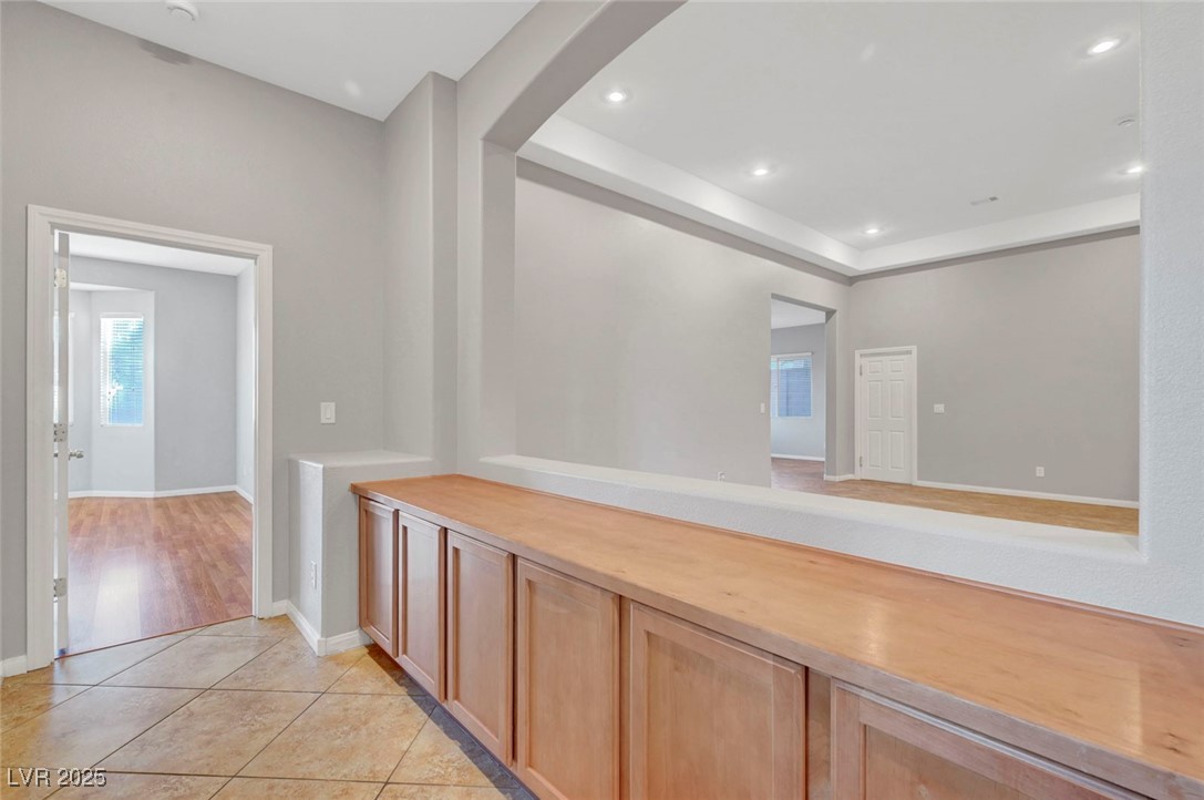 9417 Wisdom Valley Avenue Las Vegas, NV 89149 - Photo 29 of 67 Hall featuring light tile patterned floors, recessed lighting, and arched walkways