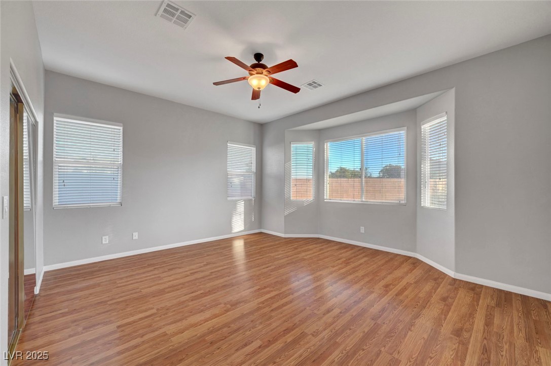 9417 Wisdom Valley Avenue Las Vegas, NV 89149 - Photo 31 of 67 Empty room featuring light wood-style flooring, plenty of natural light, and a ceiling fan