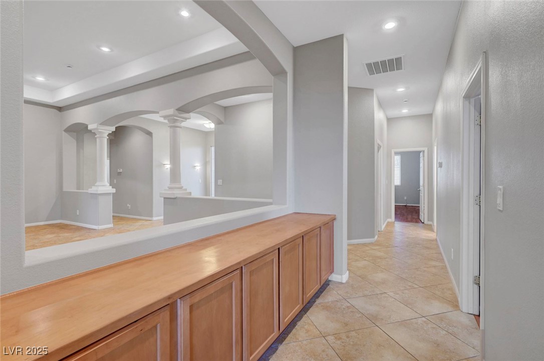 9417 Wisdom Valley Avenue Las Vegas, NV 89149 - Photo 41 of 67 Hall featuring light tile patterned floors, recessed lighting, and arched walkways
