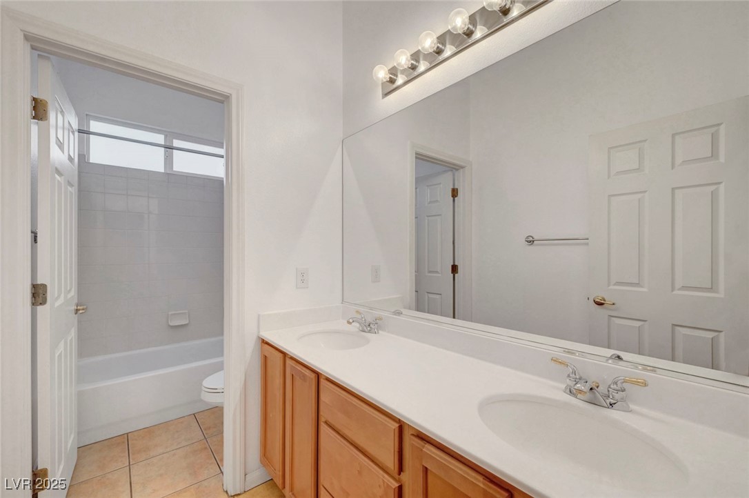 9417 Wisdom Valley Avenue Las Vegas, NV 89149 - Photo 48 of 67 Bathroom with light tile patterned floors, shower / tub combination, and double vanity