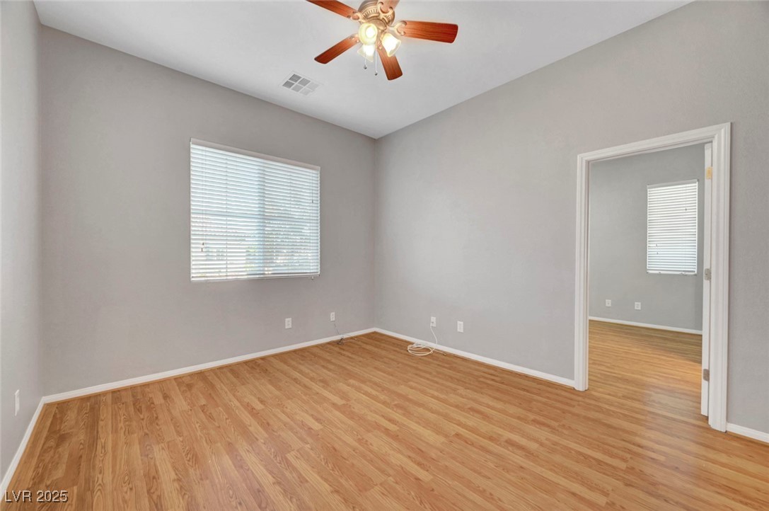 9417 Wisdom Valley Avenue Las Vegas, NV 89149 - Photo 50 of 67 Empty room featuring light wood-style floors and ceiling fan