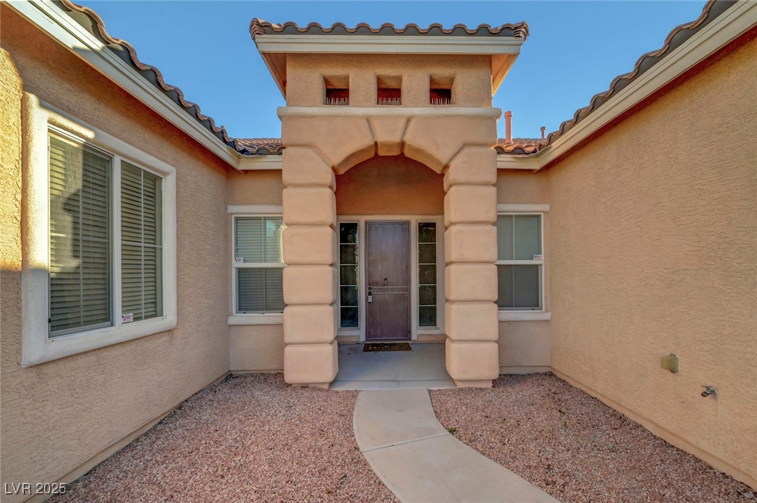 9417 Wisdom Valley Avenue Las Vegas, NV 89149 - Photo 5 of 67 Property entrance featuring a tile roof and stucco siding
