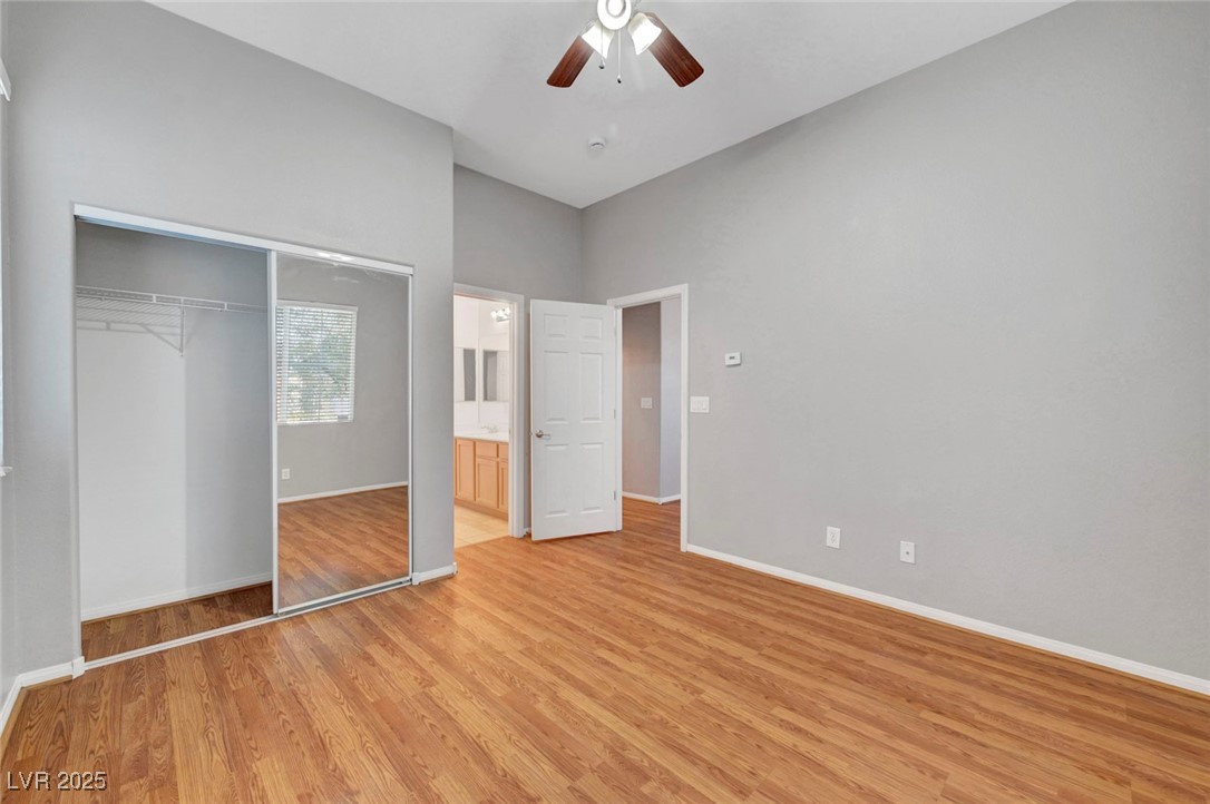 9417 Wisdom Valley Avenue Las Vegas, NV 89149 - Photo 52 of 67 Unfurnished bedroom featuring light wood-style flooring, a closet, ceiling fan, and ensuite bathroom