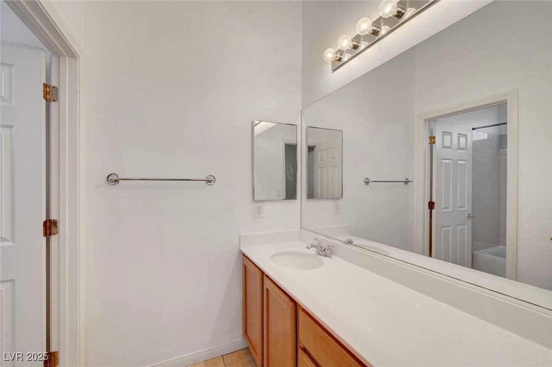 9417 Wisdom Valley Avenue Las Vegas, NV 89149 - Photo 53 of 67 Bathroom featuring vanity, bathing tub / shower combination, and light tile patterned flooring