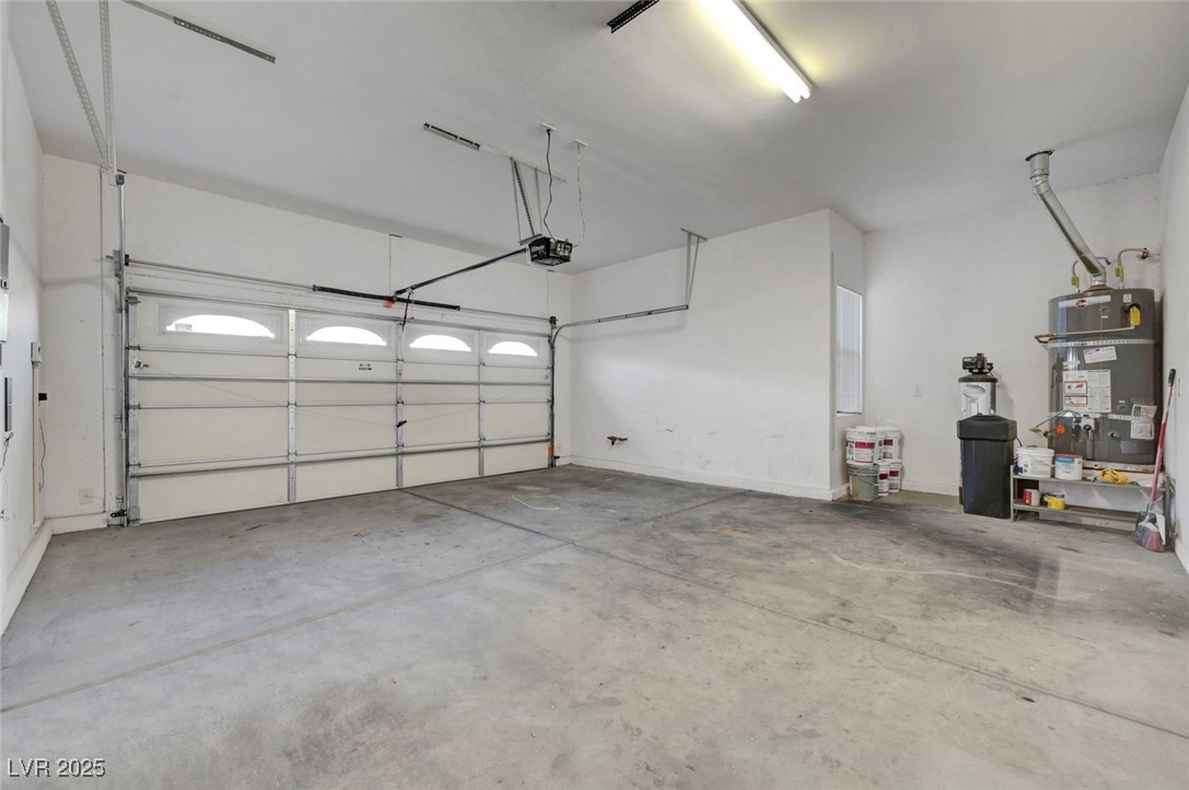 9417 Wisdom Valley Avenue Las Vegas, NV 89149 - Photo 56 of 67 Garage featuring water heater and a garage door opener