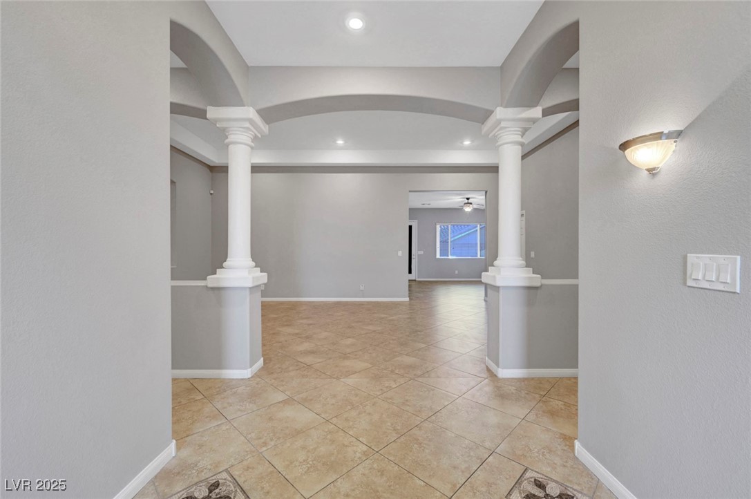 9417 Wisdom Valley Avenue Las Vegas, NV 89149 - Photo 6 of 67 Hall with light tile patterned floors, ornate columns, and recessed lighting