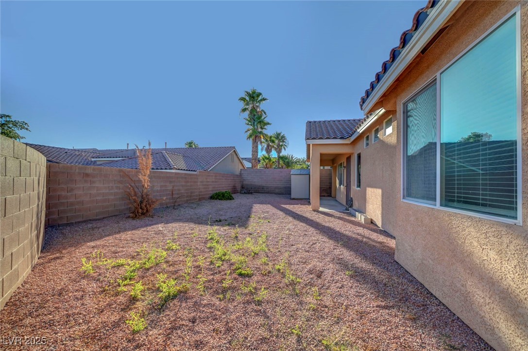 9417 Wisdom Valley Avenue Las Vegas, NV 89149 - Photo 66 of 67 Fenced backyard featuring a patio area