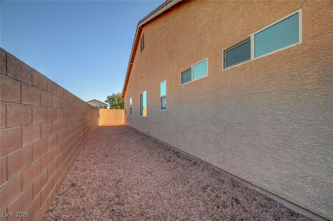 9417 Wisdom Valley Avenue Las Vegas, NV 89149 - Photo 67 of 67 View of property exterior featuring stucco siding and a fenced backyard