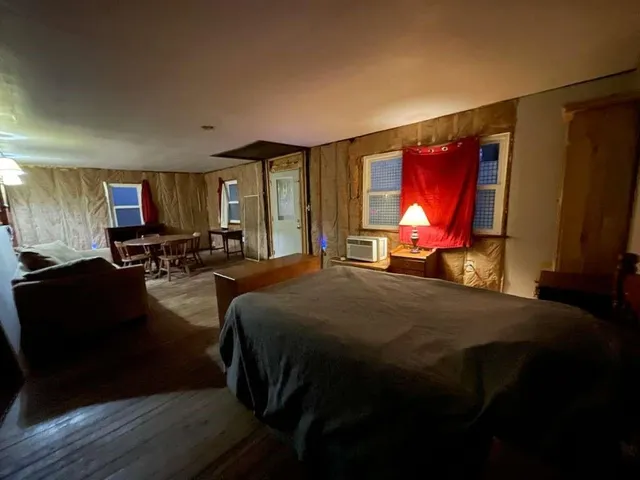 a bed room with a bed and mirror