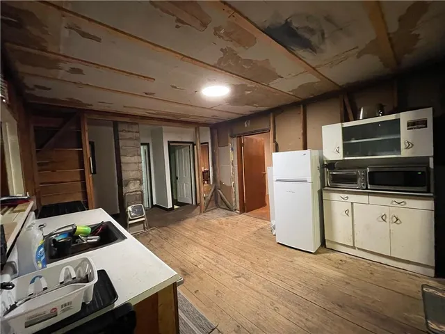 a kitchen with refrigerator and cabinets