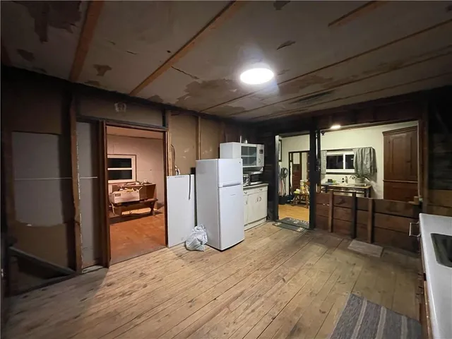 a kitchen with refrigerator and microwave