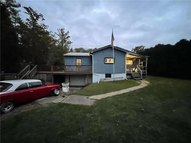 a front view of a house with a garden and yard