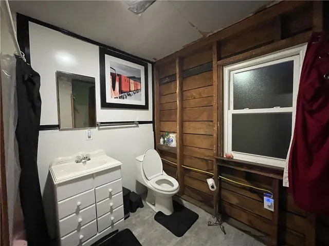 a bathroom with a toilet sink and mirror
