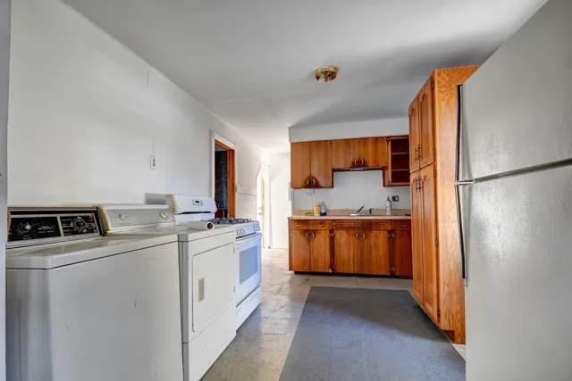 a kitchen with a refrigerator sink stove and oven